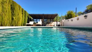 a swimming pool with turquoise water at Casa La Alegria 37 in Málaga