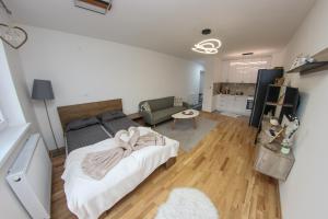 a bedroom with a bed and a living room at Apartman Imperial 7 in Sarajevo