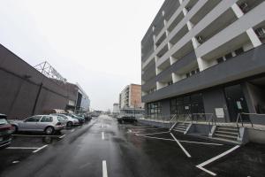 a parking lot with cars parked next to a building at Apartman Imperial 7 in Sarajevo