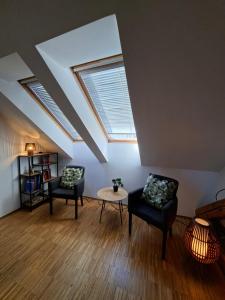 a living room with two chairs and a table at AMS Rooms in Ljubljana