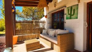 a porch with a wicker bench on a patio at Casa La Alegria 37 in Málaga +28 photos