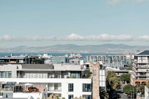 a view of a city with mountains in the background at Cape Finest - De Waterkant House in Cape Town +28 photos