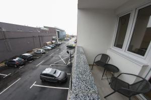 a balcony with a car parked in a parking lot at Apartman Imperial 7 in Sarajevo