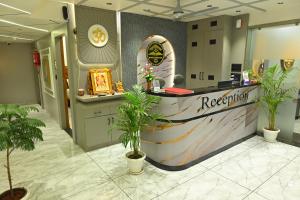 a reception desk in a store with potted plants at Hotel Revanta Inn in Ahmedabad