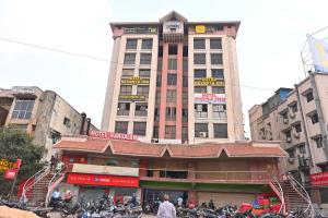 a large building with motorcycles parked in front of it at Hotel Revanta Inn in Ahmedabad