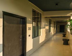an empty hallway of a building with a door at Minimalist One Hauz Khas Village in New Delhi