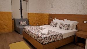 a hotel room with a bed and a couch at Casa D`Auleira in Ponte da Barca +76 photos
