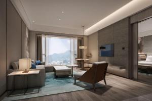 a living room with a couch and a bed at Courtyard by Marriott Jiuzhaigou in Jiuzhaigou +26 photos