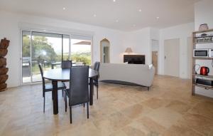 a living room with a table and chairs and a couch at "Vigna d’Eugène" – T3 Piscine | by Efficios in Petreto-Bicchisano