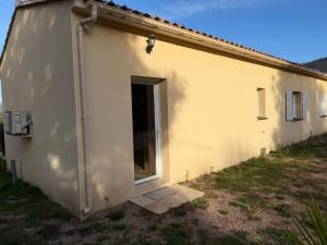 a small white building with a door on the side at "Vigna d’Eugène" – T3 Piscine | by Efficios in Petreto-Bicchisano +4 photos
