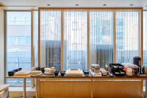an office with large windows with a view of the city at Tosei Hotel Cocone Ueno in Tokyo