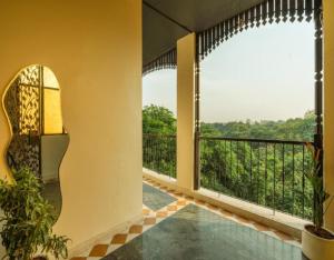 a room with a balcony with a view at Minimalist One Hauz Khas Village in New Delhi