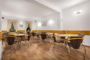 a row of tables and chairs in a room at Pensiunea Kronstadt in Braşov