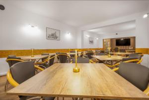 a conference room with wooden tables and chairs at Pensiunea Kronstadt in Braşov