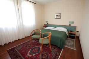 Postel nebo postele na pokoji v ubytování Hotel Valbrenta