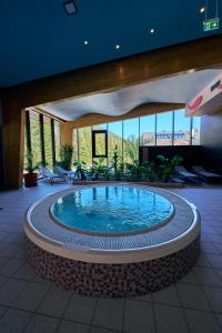 a large swimming pool in a building at Wellness Hotel Chopok in Belá