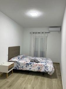 a bedroom with a bed and a table in it at El rincón del pintor in Villacañas