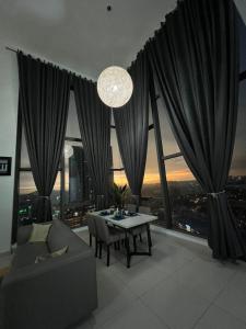 a living room with a table and a large window at Kita Retail Management Sdn Bhd in Bandar Baru Bangi