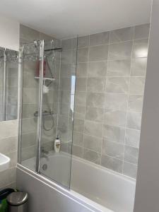 a bathroom with a shower and a bath tub at Quiet double bedroom in Yapton