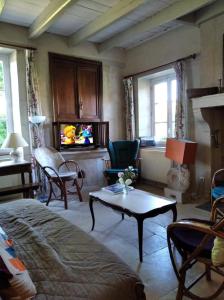 a living room with a couch and a table at Gîte robale in Romagne