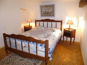 a bedroom with a wooden bed and two night stands at Gîte robale in Romagne