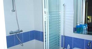 a shower in a bathroom with blue and white tiles at Gîte robale in Romagne +10 photos