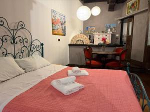 a bedroom with a bed with two towels on it at Assisi 2 by E-Roi Rent - Museo Egizio in Turin