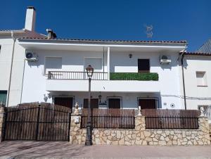 a white house with a fence in front of it at El DESAFÍO in Riópar