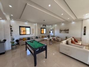a living room with a pool table in it at Villa Bonheur - Piscine sans vis-à-vis in Berkane