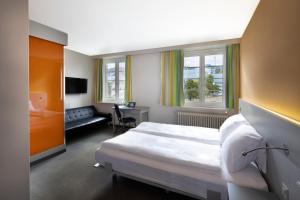 a hotel room with a bed and a desk at Hotel & Gasthaus Die Perle in Perlen