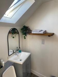 a bathroom with a sink and a mirror at Yew Trees Barn in Backwell +37 photos