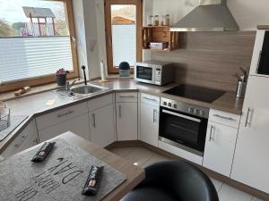 a kitchen with a sink and a stove top oven at Ferienwohnung Klara in Hilchenbach +5 photos
