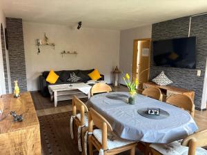 a living room with a table and a couch at Ferienwohnung Klara in Hilchenbach