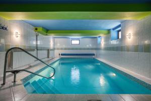 a swimming pool with a blue water in a building at Hotel Stara Posta in Filipovice