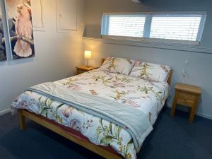 a bedroom with a bed and a window at 2 Bedroom Unit in Howick in Auckland