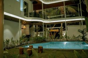 an apartment building with a swimming pool and a balcony at Arthanaa Villa in Mysore