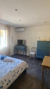 a bedroom with a bed and a dresser and a desk at Les lauriers fleuris in Méounes-lès-Montrieux +28 photos