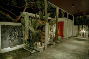 a room with a bunch of plants on the wall at Arthanaa Villa in Mysore