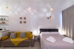 a bedroom with a bed and a couch at Idumea Rooms in Lecce
