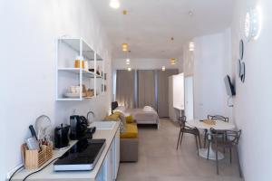 a kitchen and living room with a couch and a table at Idumea Rooms in Lecce