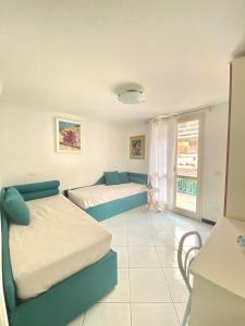 a bedroom with two beds and a balcony at FRANCESCA'S HOUSE in Minori