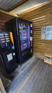 a refrigerator in a room with a wooden wall at CCA area in Hio