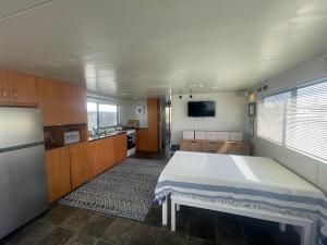 a kitchen with a large bed in a room at Mandurah Houseboat Just Chillin in Mandurah