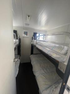 a couple of bunk beds in a room at Mandurah Houseboat Just Chillin in Mandurah