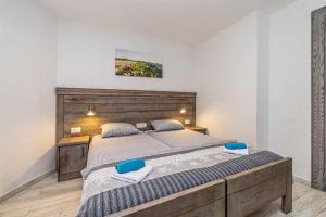 a bedroom with a large bed with two towels on it at Rustikalna kuća za odmor VILLA MARE in Kornić +34 photos