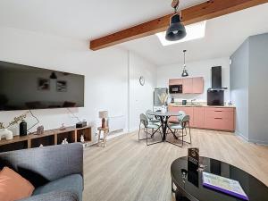 a living room with a couch and a table at Tour d'Auvergne - Appartements en plein centre ville, proche de la cathédrale et de la place de Jaude in Clermont-Ferrand