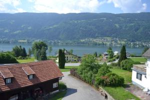 a view of a town with a lake and mountains at Merlschober, Ferienwohnung 3, Ossiacher See in Ossiach