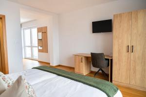 a bedroom with a bed and a desk with a computer at Penzión Slnečná in Lendak +7 photos