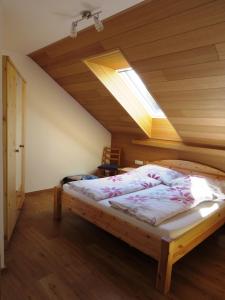 a bedroom with a bed with a skylight at Tremlhof in Unterach am Attersee