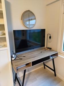 a large flat screen tv sitting on top of a table at Cozy Apartment in Nørresundby